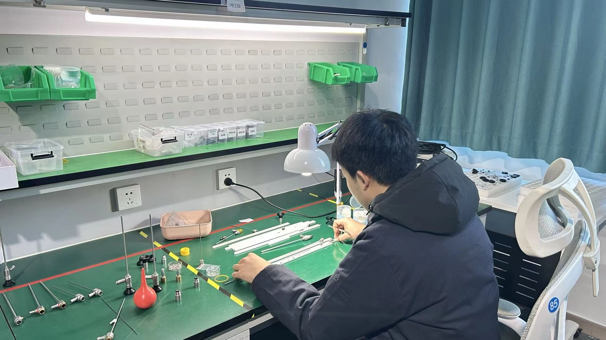 Technician assembling and testing medical endoscope in production workshop Technician assembling and testing medical endoscope in production workshop